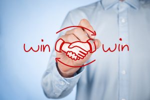 Win-win partnership strategy concept. Businessman draw win-win scheme and handshake partnership agreement.